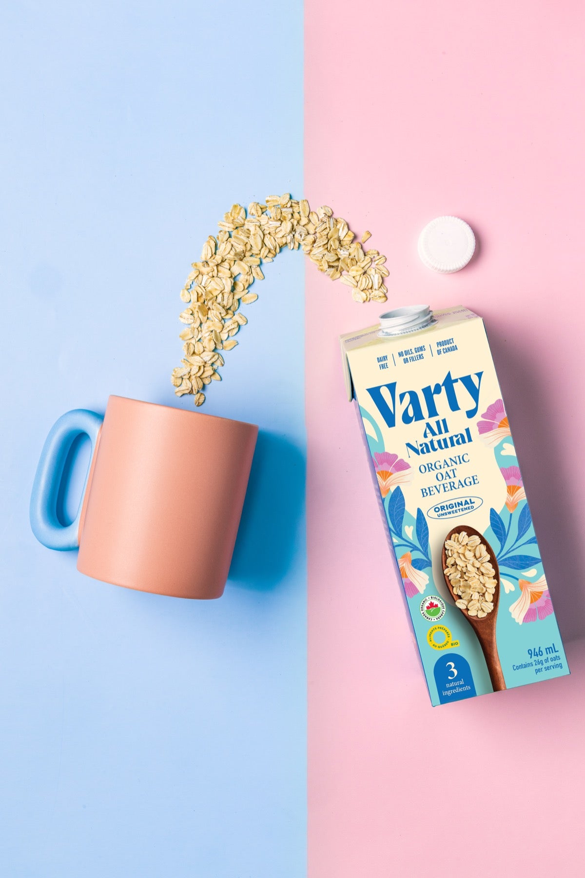 Oats pouring into a mug next to a Varty carton